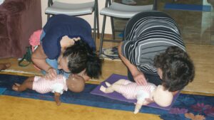Cpr class practicing infant chest compressions.