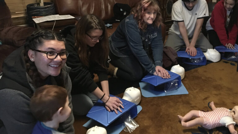 CPR class participants demonstrating chest compressions.