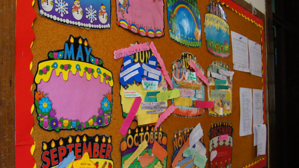 Bright bulletin board showing birthday cakes for each month of the year.